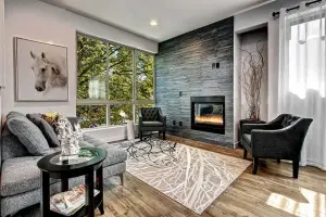 Natural oak wood-plank floor, living room with stacked-stone fireplace