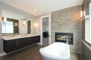 Brown rectangular porcelain tile floor in offset layout, primary bath