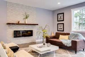 Light oak hardwood floor, living room with stacked-stone fireplace