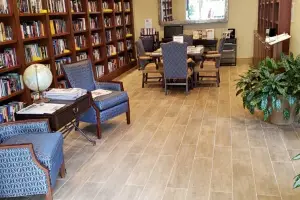 Travertine-look porcelain tile floor, senior-living library lounge