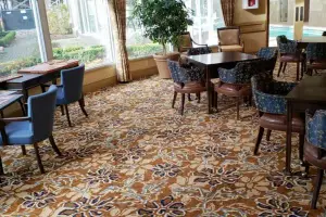 Floral patterned broadloom carpet, common-area dining room