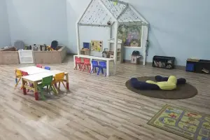 Gray wood-look luxury vinyl plank floor, childcare play room