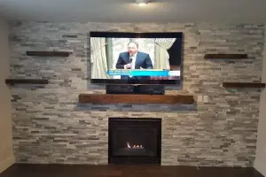Dark hardwood plank floor with stacked-stone fireplace wall, living room