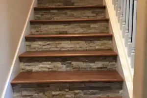 Oak hardwood stair treads with stacked-stone tile risers