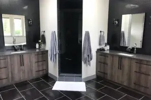 Dark wood-look tile floor in offset plank layout, primary bath