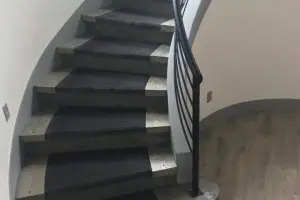 Dark carpet stair treads with light wood-look laminate landing